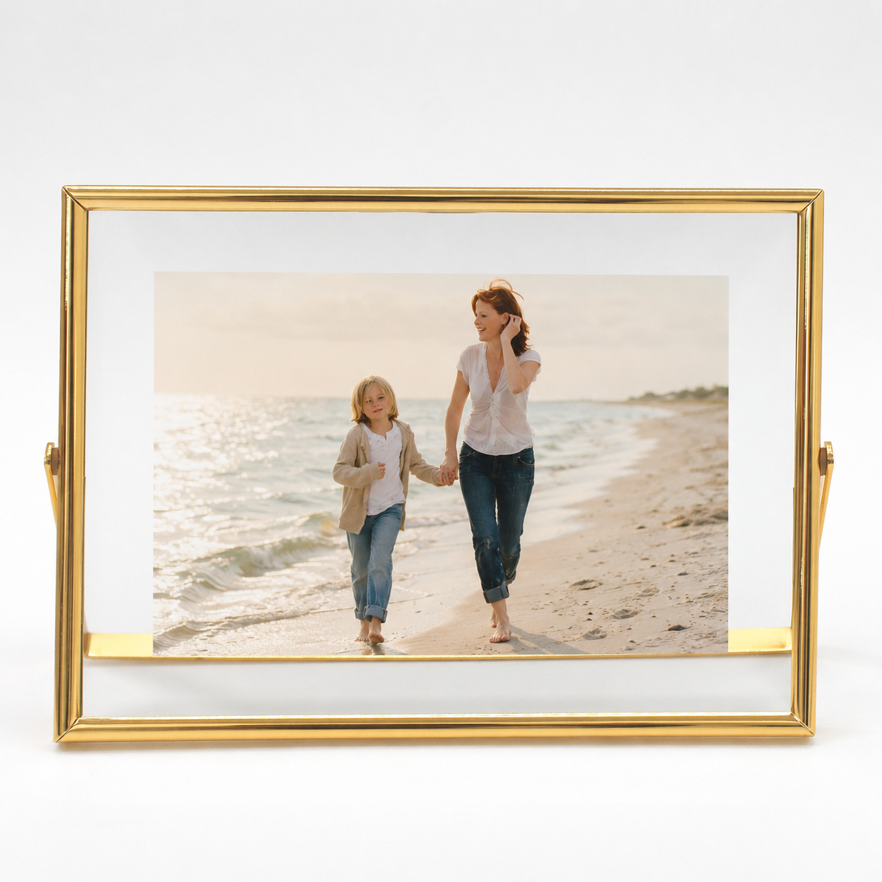 Gold metal floating photo frame with a cherished family beach portrait.