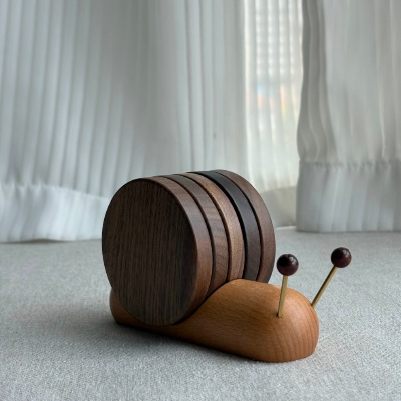Personalized wooden snail coaster set with walnut coasters and beech holder.