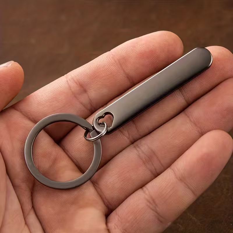 Personalized emergency contact keychain: slim custom metal tag on key ring in hand