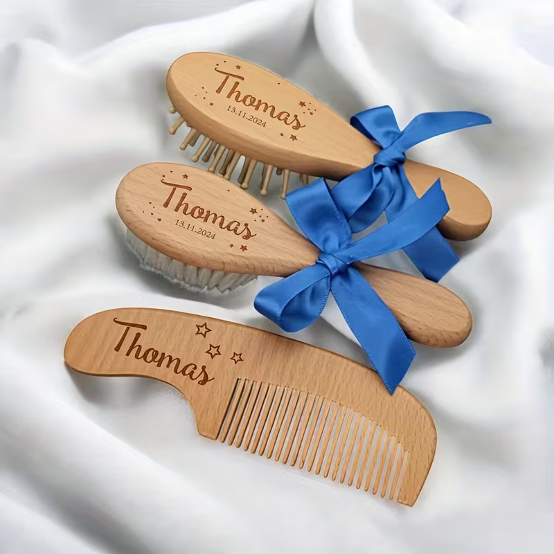 Personalized 3-piece wooden baby brush and comb set with blue ribbon.