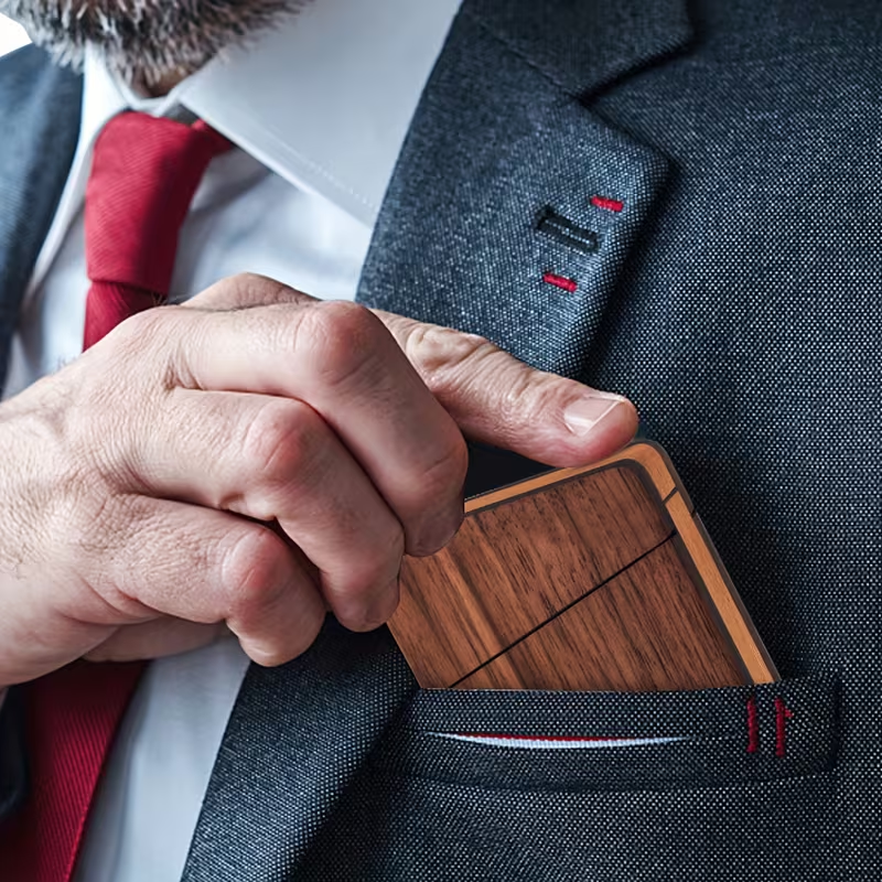 Personalized dark wood-grain card holder pulled from a suit breast pocket