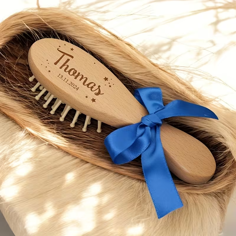 Personalized wooden baby brush engraved Thomas with royal blue bow, from 3-piece set.